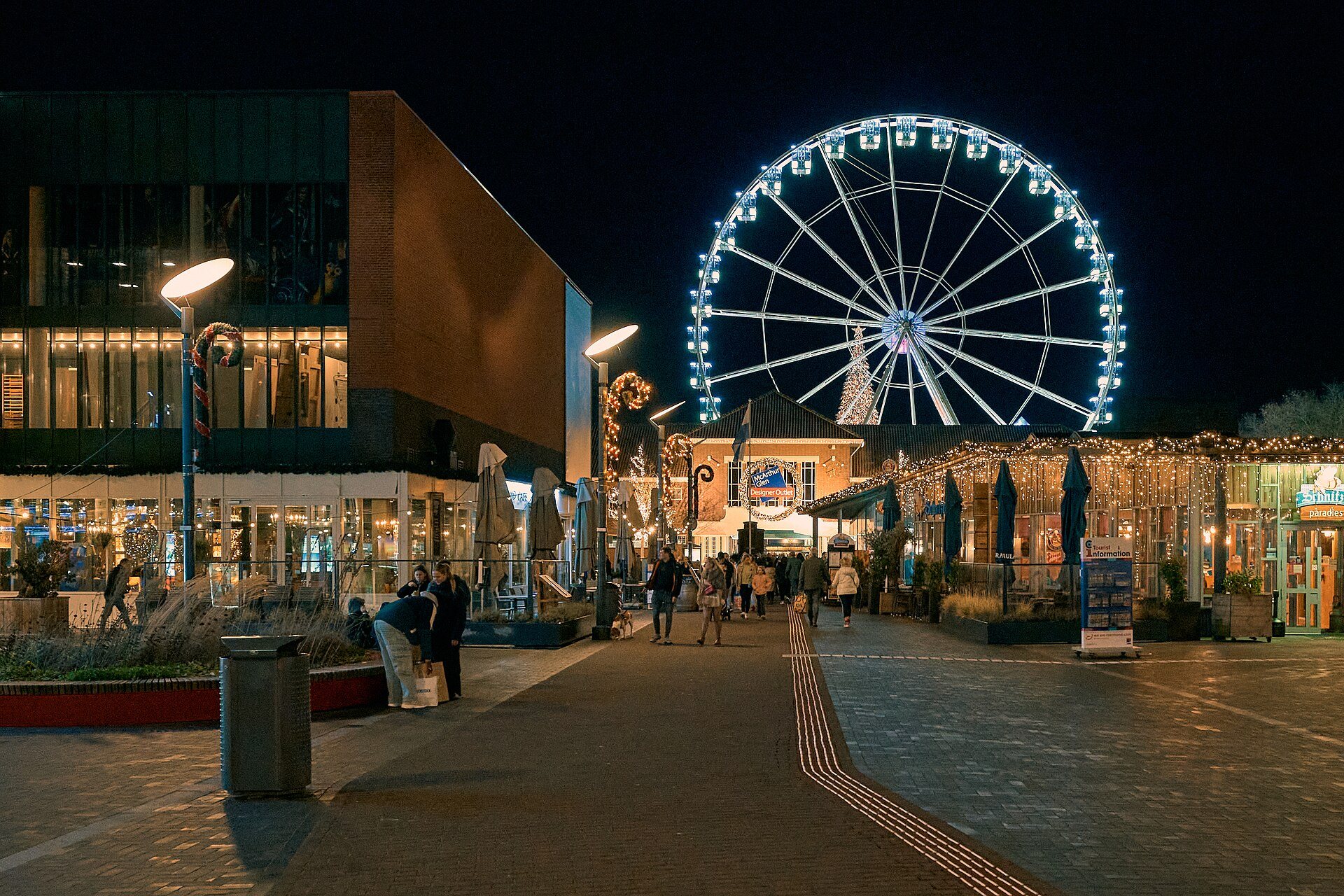 Eingang des Designer Outlet Roermond mit Riesenrad in der Weihnachtszeit